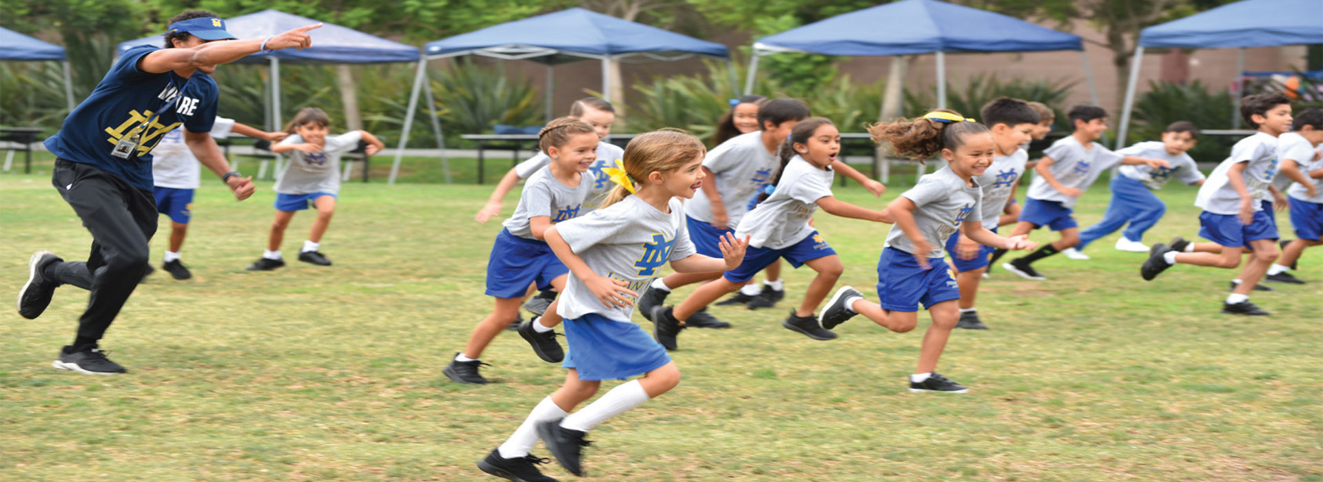 Student running in the athletics field under the direction of Mr. Smith
